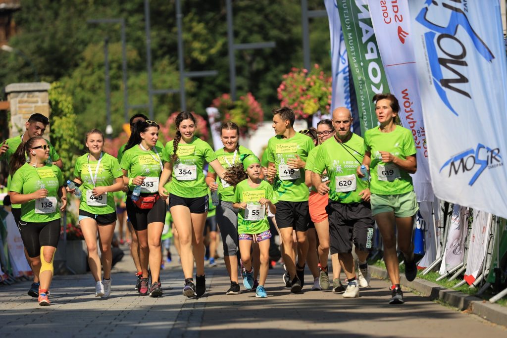 Grupa biegaczy w zielonych koszulkach
